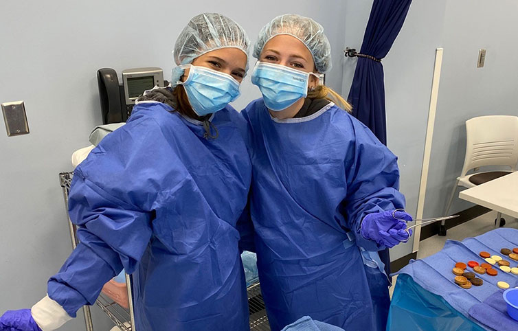 two high school students at scrubs camp in the Anoka Tech surgical technology lab