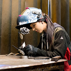 Welding alum Gerrilyn creating flower