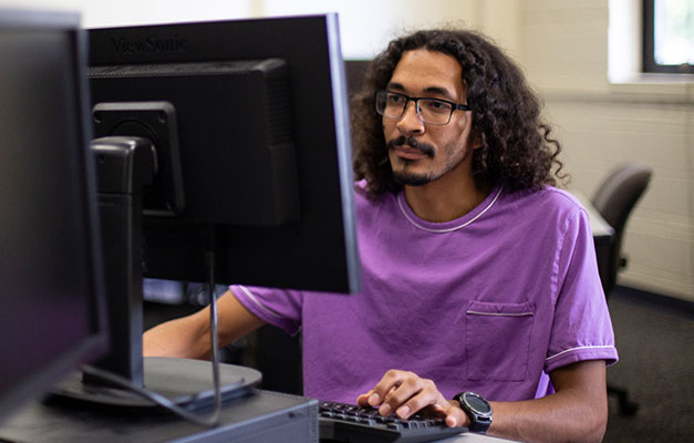 Student Working on the Computer in the Library 