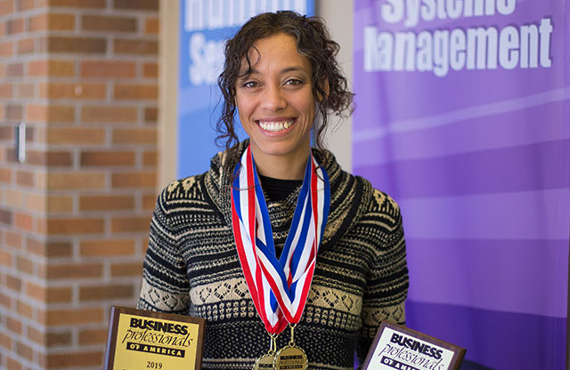 Natalie Zabrzenski poses with awards