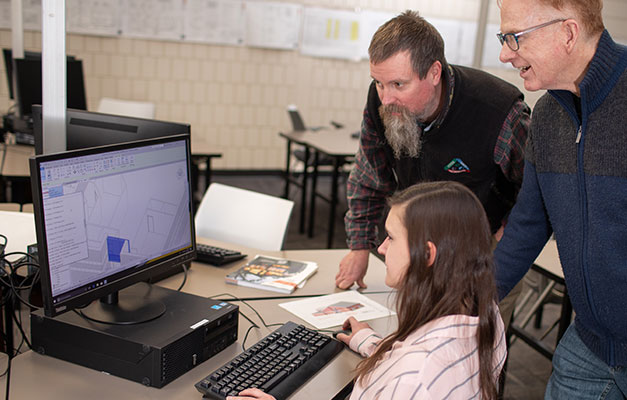 An Architecture Student Working at a Computer with Two Professors.