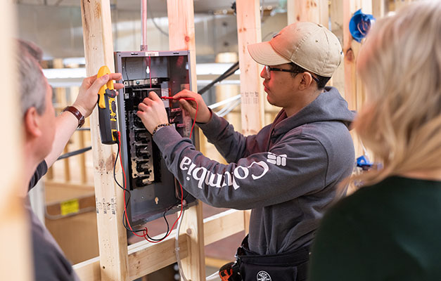 Student Working with Construction Electrician Equipment at Anoka Technical College.