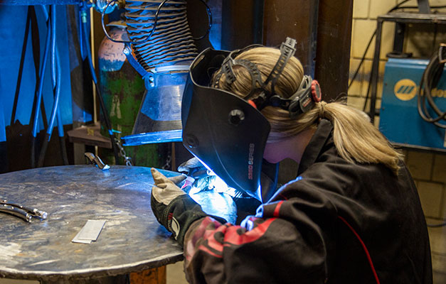 A Welding Student Working on a Project. 