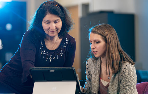 A Student and Advisor Looking at a Computer. 