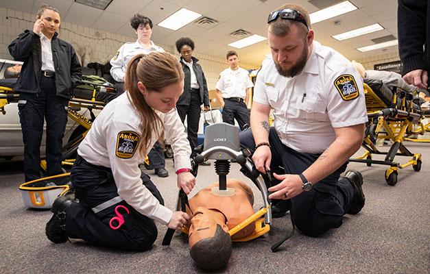 Two EMT Students Working on a Mannequin. 