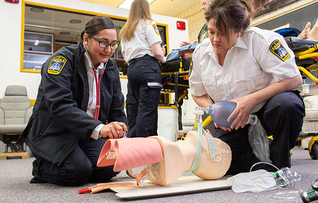 EMT Students Giving CPR on a Mannequin. 