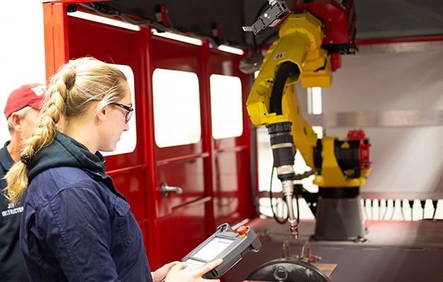 A Student and Advisor Using Robotic Equipment. 