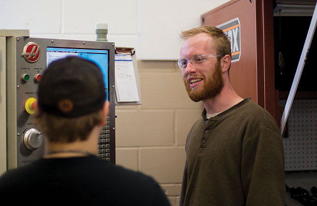 Josh Hultberg speaking with student