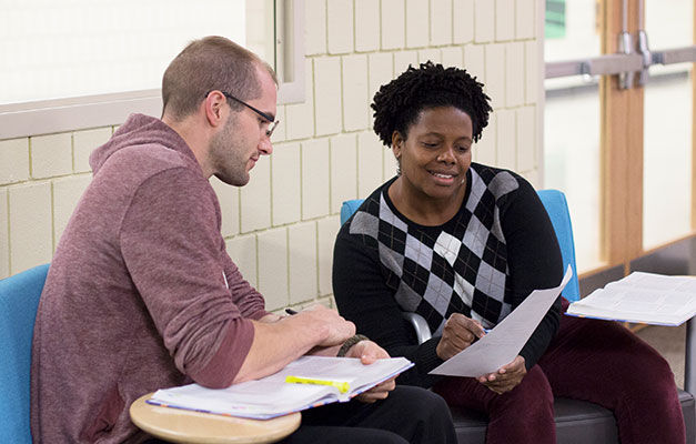 Two Students Reviewing a Class Assignment.