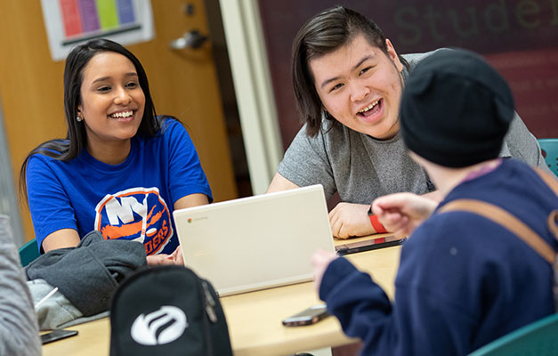 Three students talking in the student center 